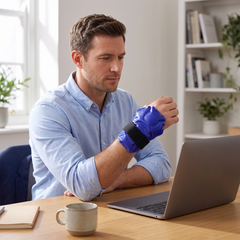 Gel ice pack wrapped around a wrist at a desk