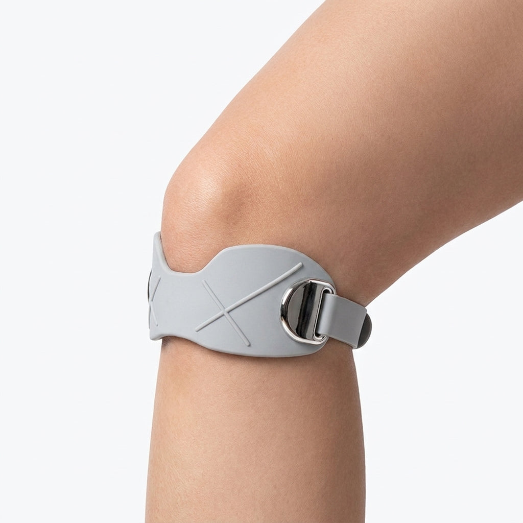 Grey silicone patella band worn on the knee