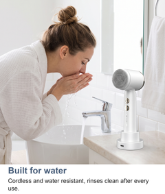 Facial cleansing brush rinsed clean at a basin