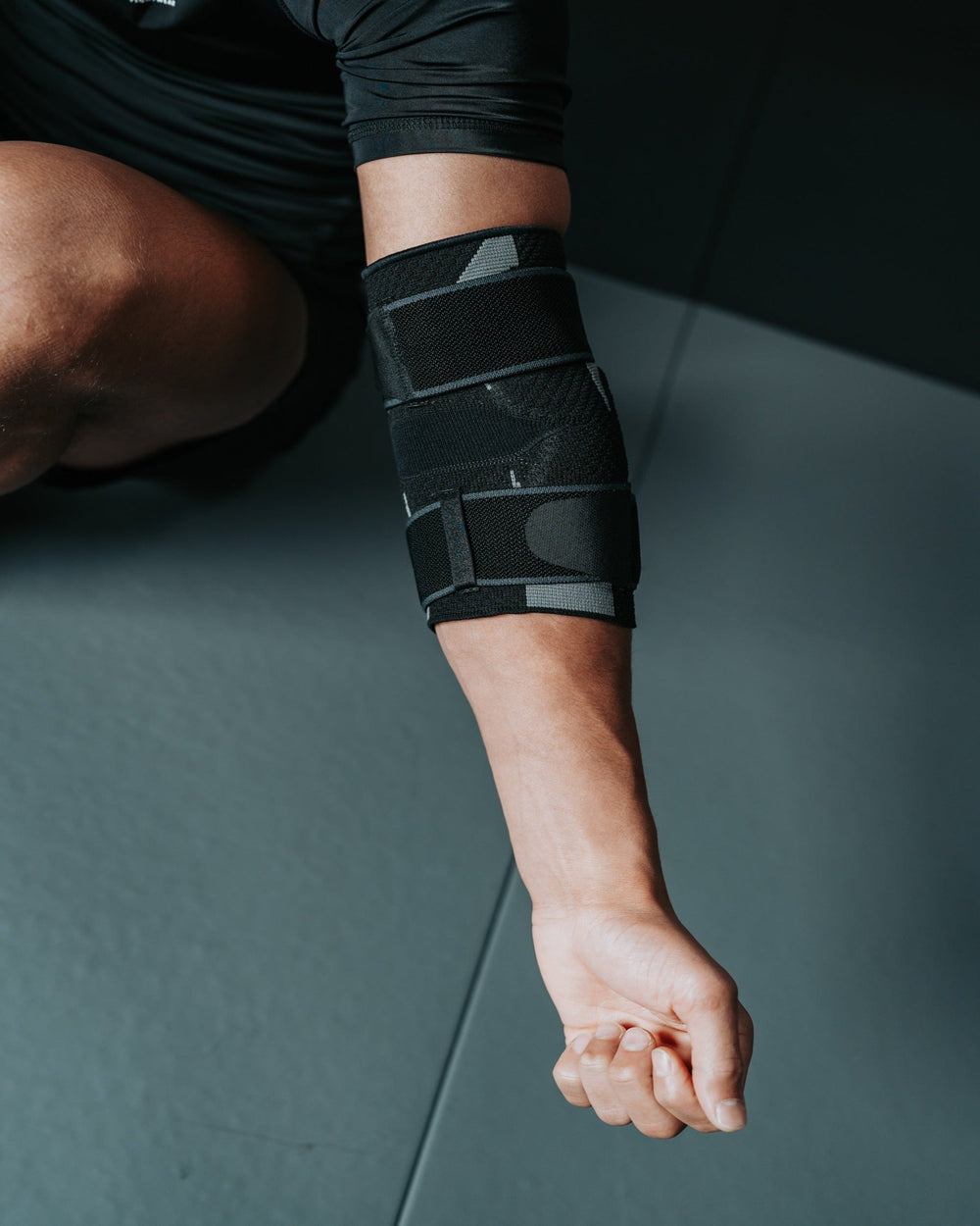 Adjustable elbow support brace with compression strap