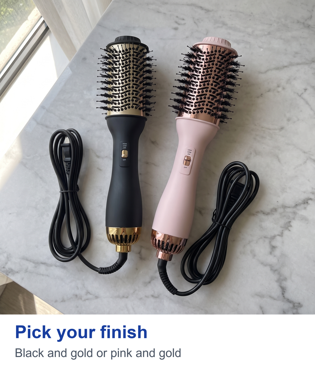 Black and pink hot air brushes laid flat side by side
