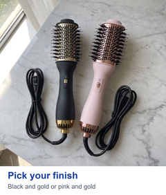 Black and pink hot air brushes laid flat side by side