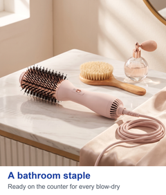 Hot air styling brush resting on a dressing table