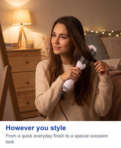 Woman finishing her hairstyle in the evening with the hot air brush