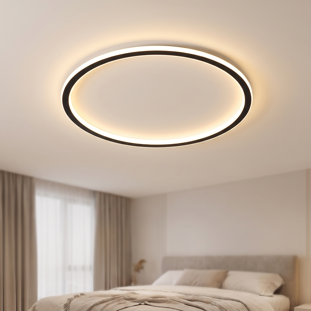 Black thin ring LED ceiling light glowing on a bedroom ceiling