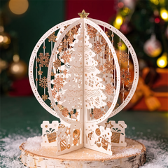 3D pop up Christmas card with a laser cut paper tree on a festive table