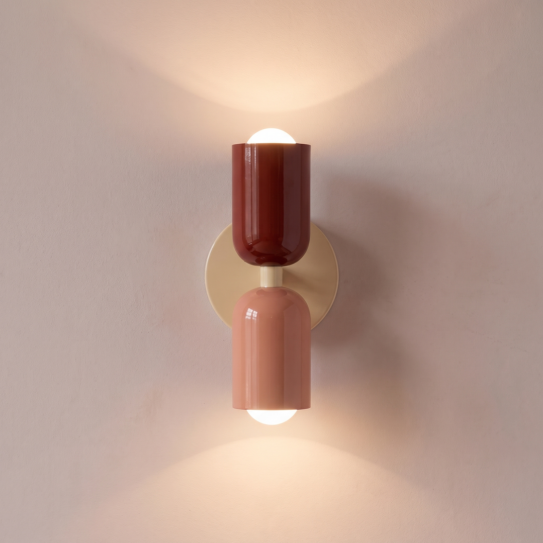 Red and salmon two tone capsule wall light shining up and down, lit