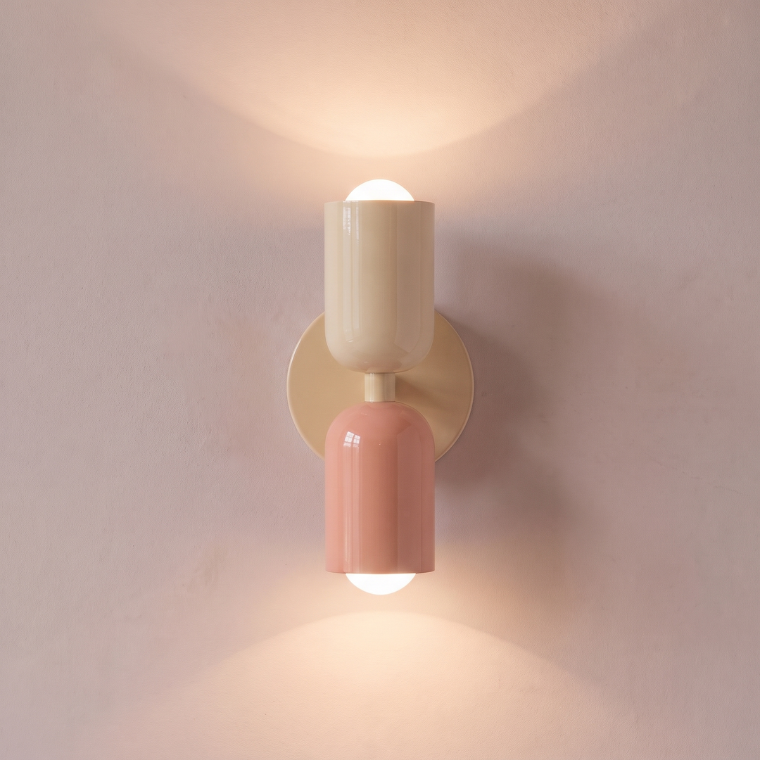 Cream and salmon two tone capsule wall light shining up and down, lit