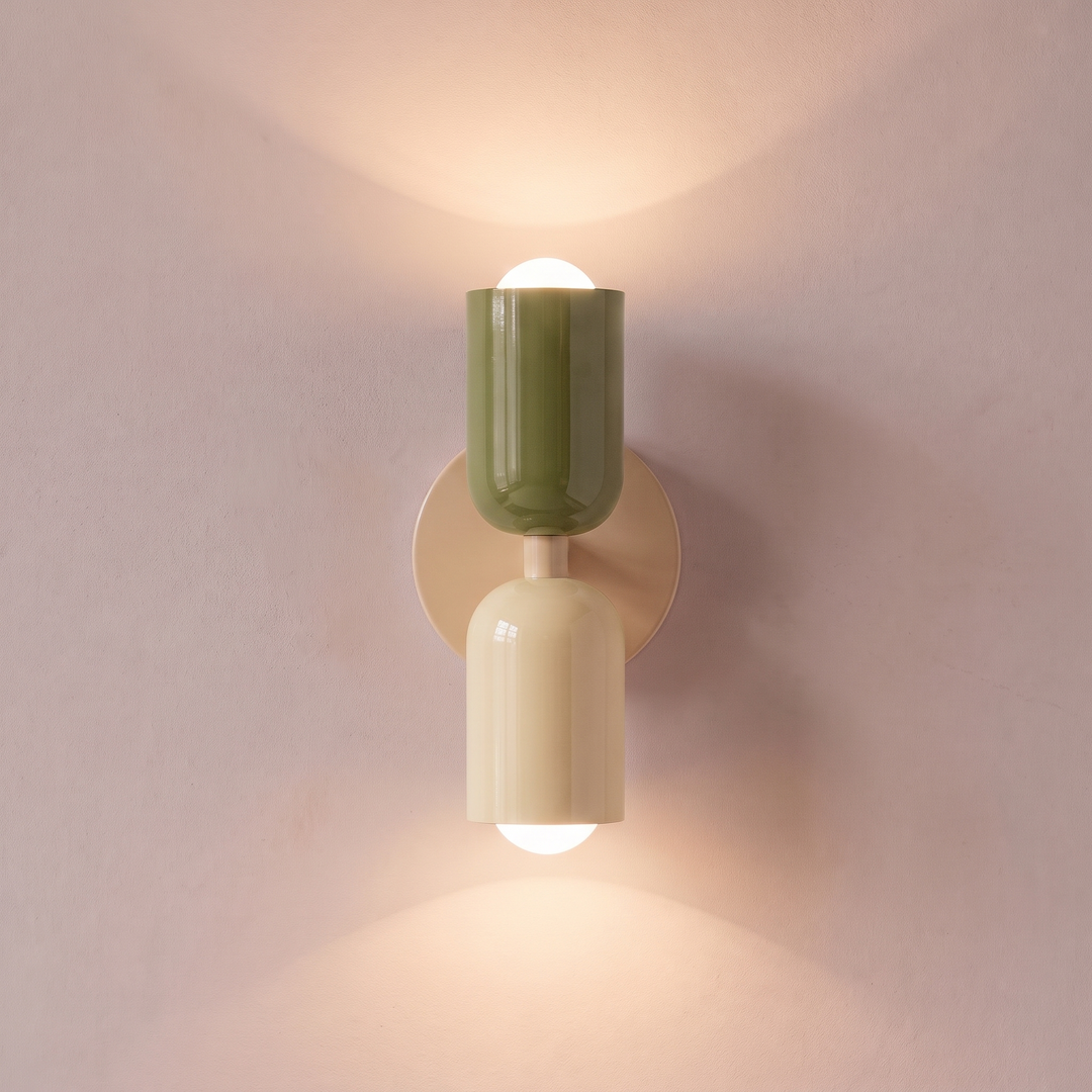 Green and cream two tone capsule wall light shining up and down, lit