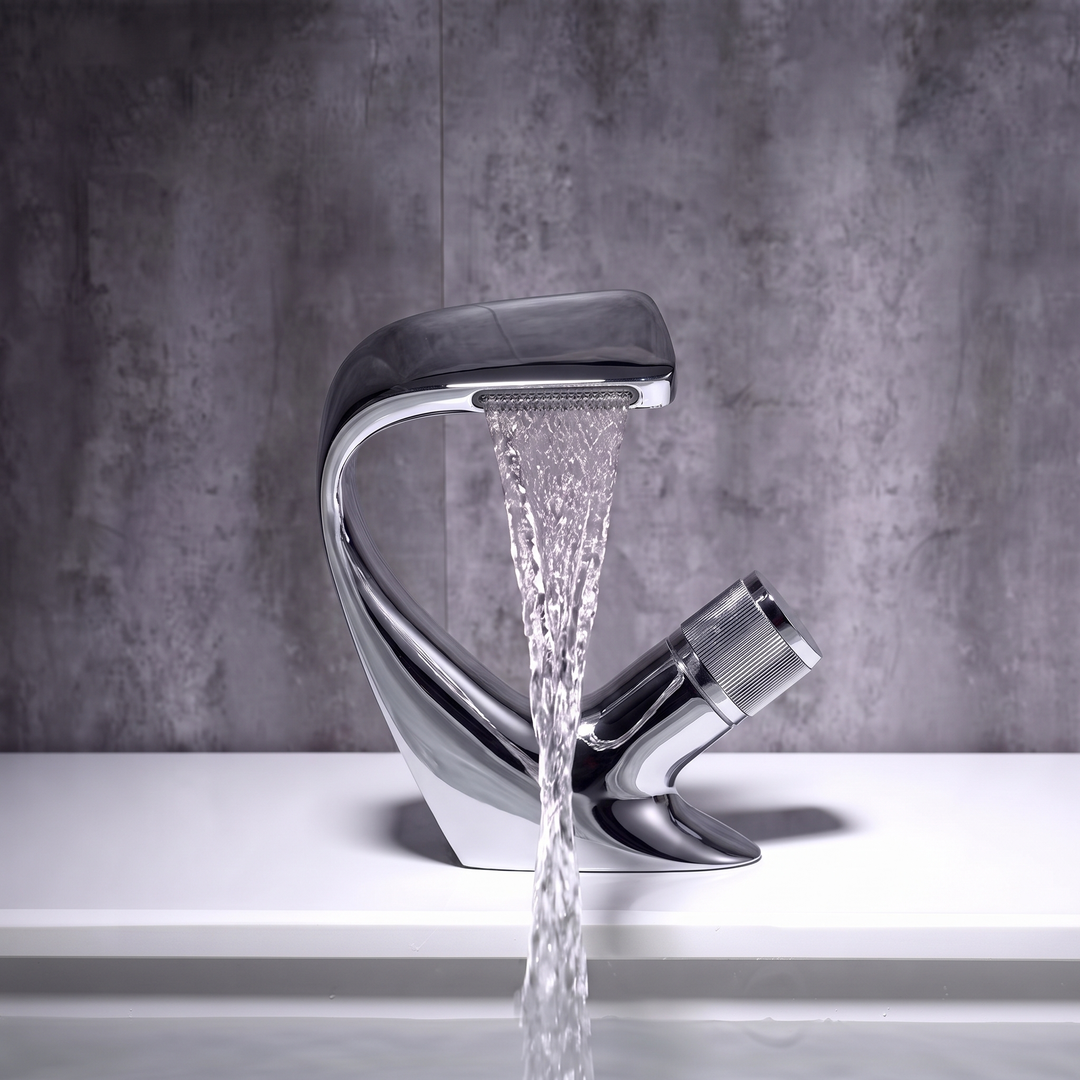 Chrome curved waterfall basin mixer tap pouring a flat sheet of water