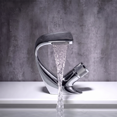 Chrome curved waterfall basin mixer tap pouring a flat sheet of water