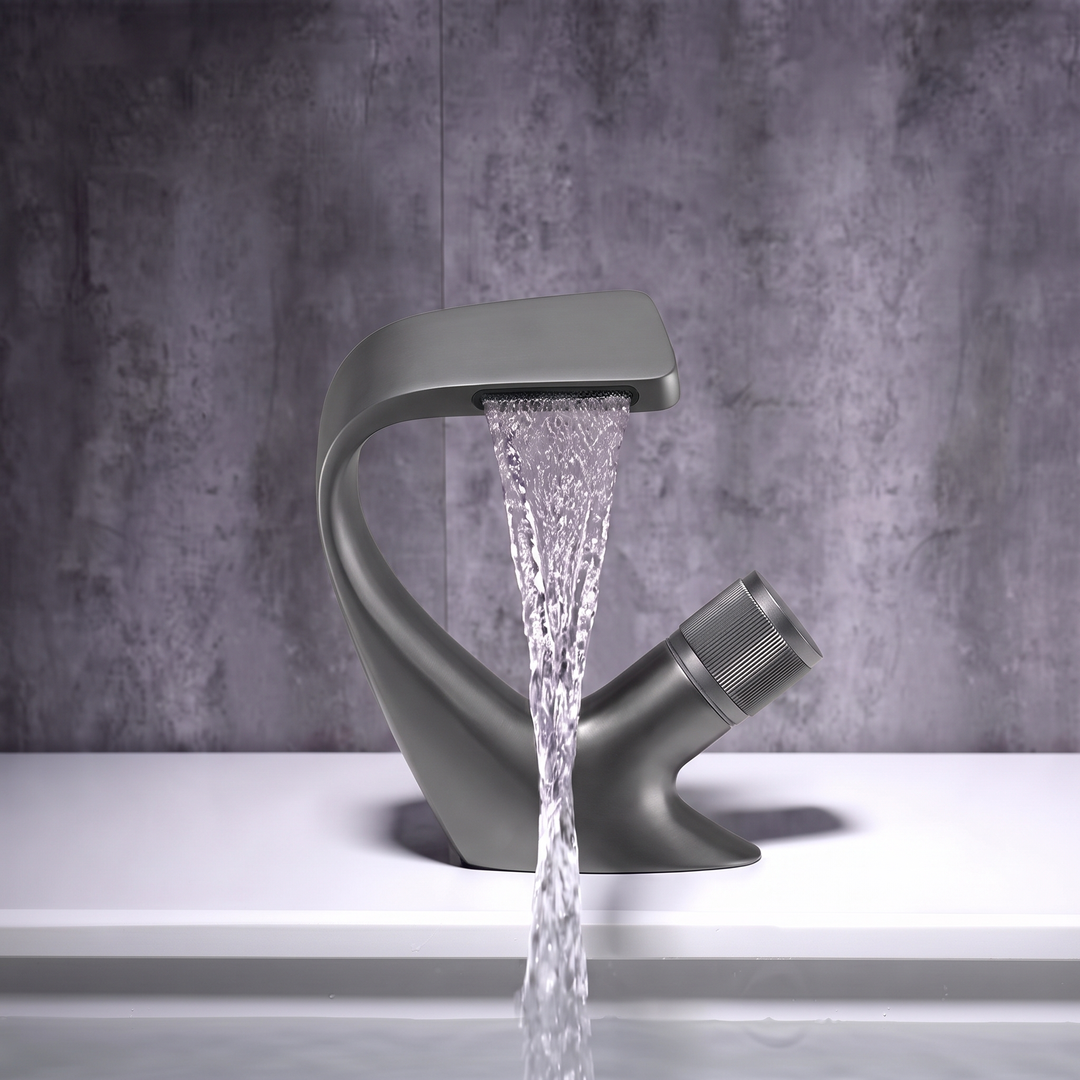Gun Metal curved waterfall basin mixer tap pouring a flat sheet of water