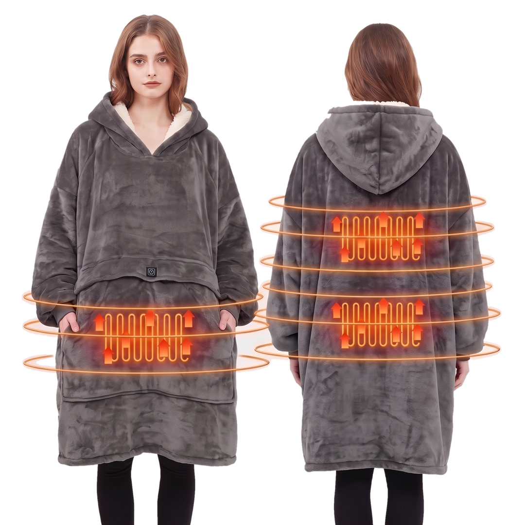Woman wearing a grey heated hoodie blanket with a sherpa lined hood in a bright living room