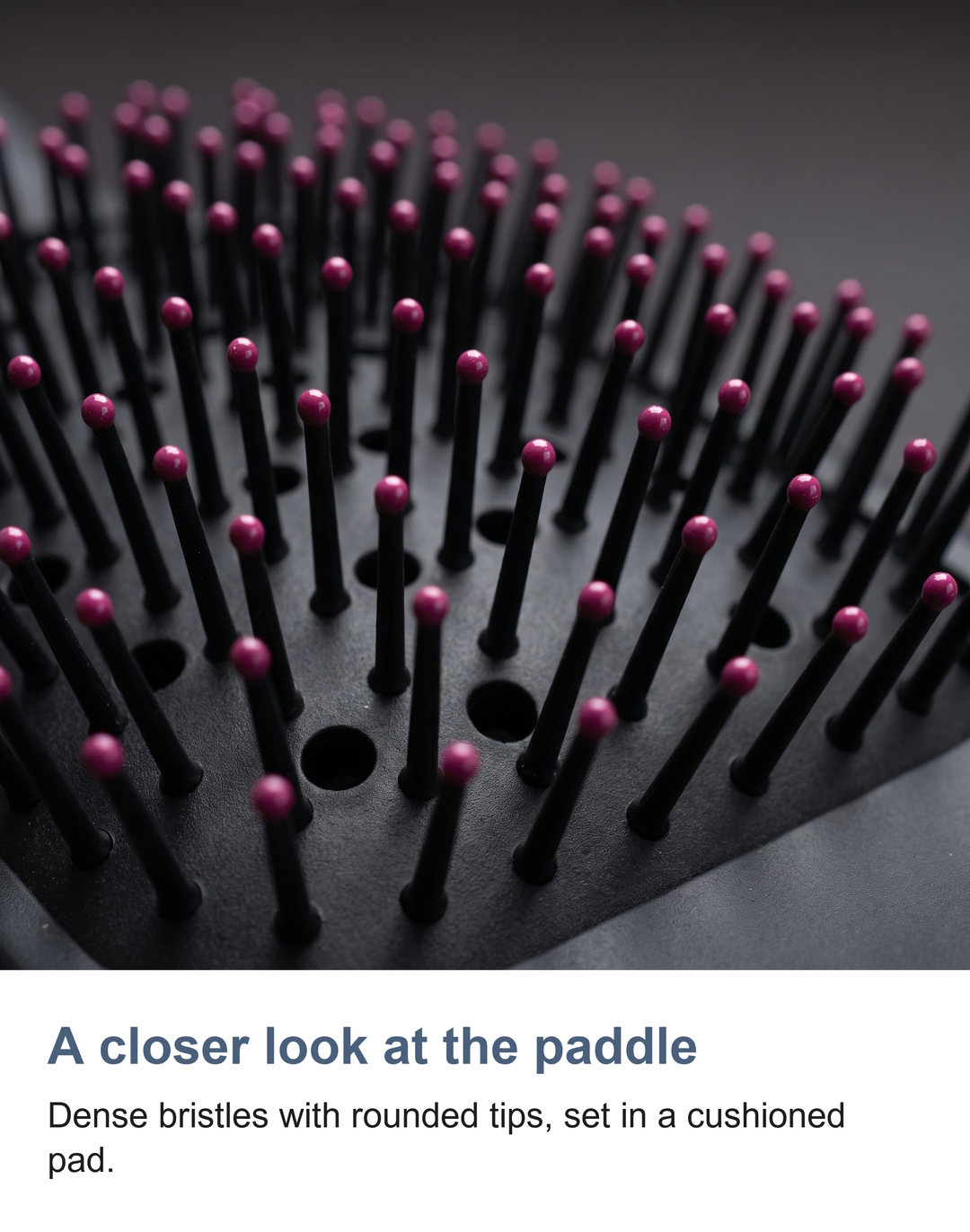 Macro of the paddle brush bristles and cushioned pad on the hair styler