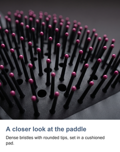 Macro of the paddle brush bristles and cushioned pad on the hair styler