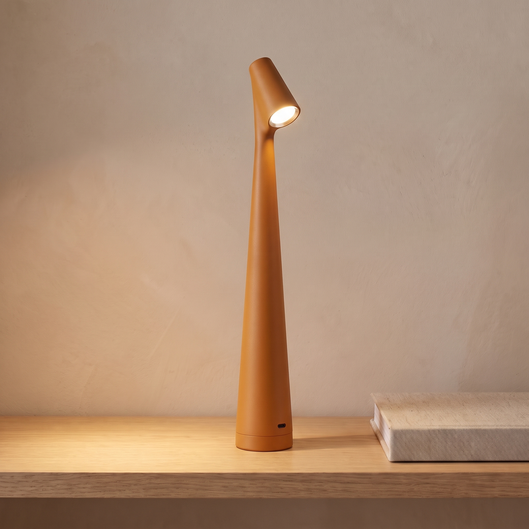 Orange cordless rechargeable table lamp on a console table