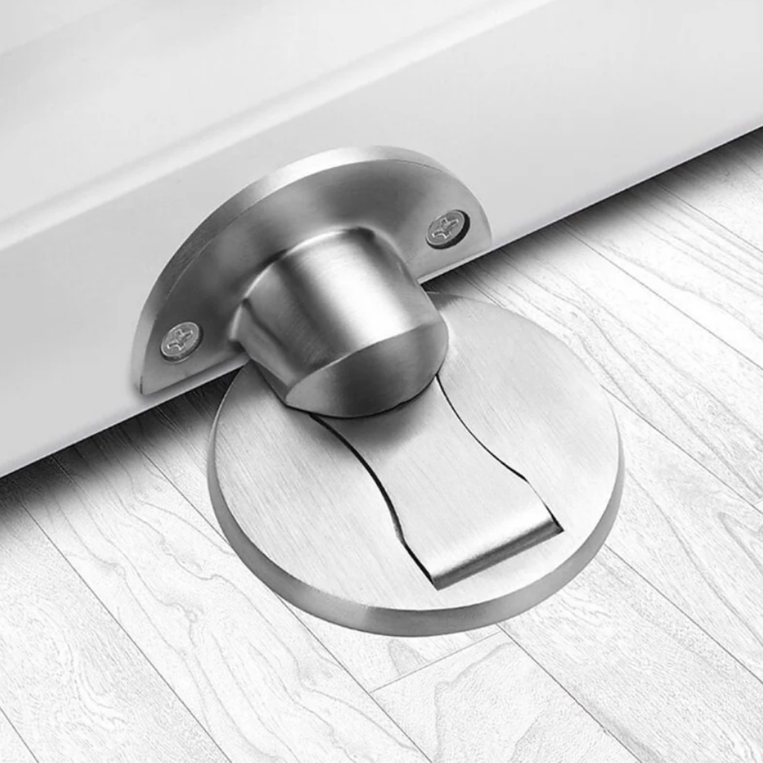 Brushed Silver magnetic stainless steel door stop on an oak floor at the bottom of an open door