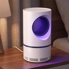 USB UV mosquito and fly trap on a bedside table with a violet glow