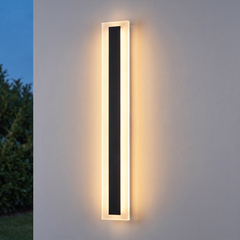Linear black LED outdoor wall light with acrylic edge glowing warm white