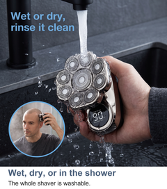 Nine-head rotary shaver held under running water at a basin, showing it is washable