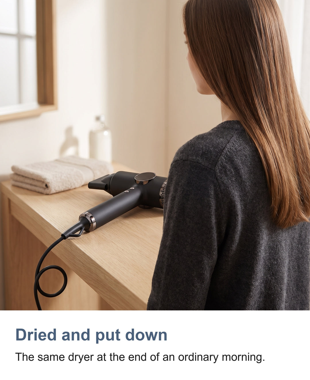 The hair dryer resting on a washbasin counter after drying