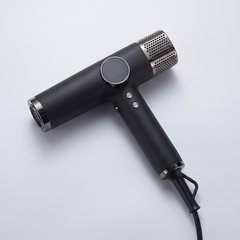Ionic hair dryer in black with a slim T shaped body, shown alone