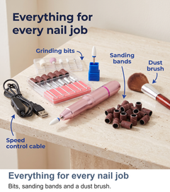 The full nail drill kit fanned out: bits, sanding bands and a dust brush