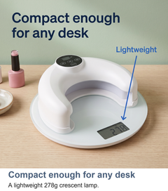Crescent nail lamp shown on a kitchen scale at 278 grams
