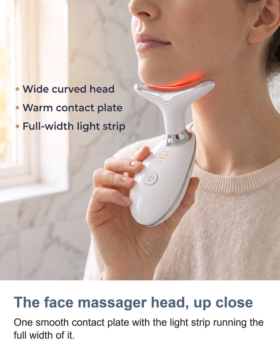 Close view of the massager head showing the smooth contact plate and the light strip running the full width of its front edge
