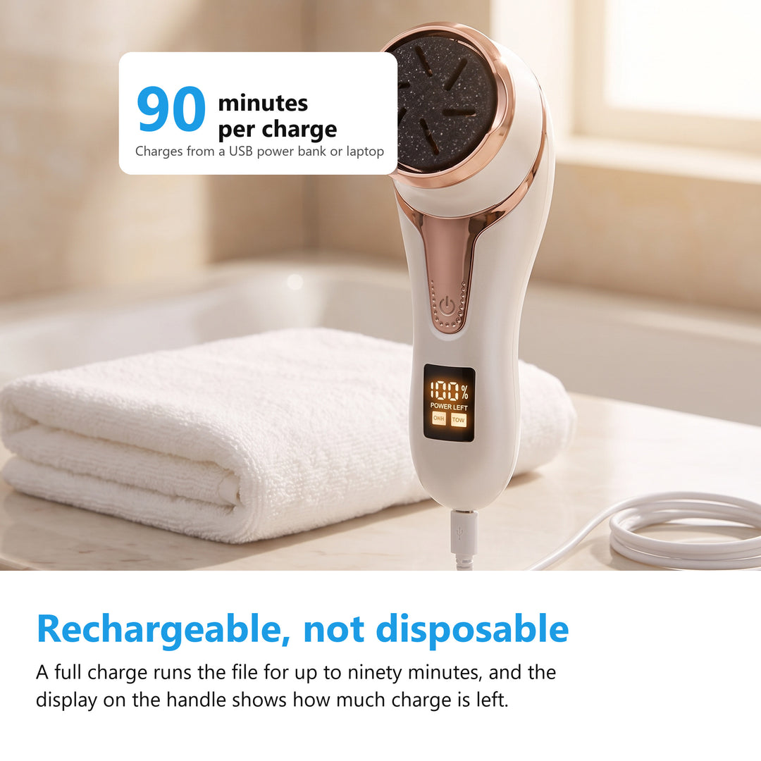 Electric foot file charging on a bathroom counter with its digital battery display lit