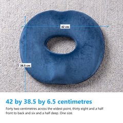 Navy donut cushion flat on a grey wool rug with measurement arrows reading 42 cm across and 38.5 cm front to back