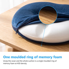 Navy donut cushion with the cover unzipped and folded back to show the white memory foam ring inside