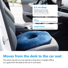 Navy donut cushion sitting on the driver seat of a car with the door open