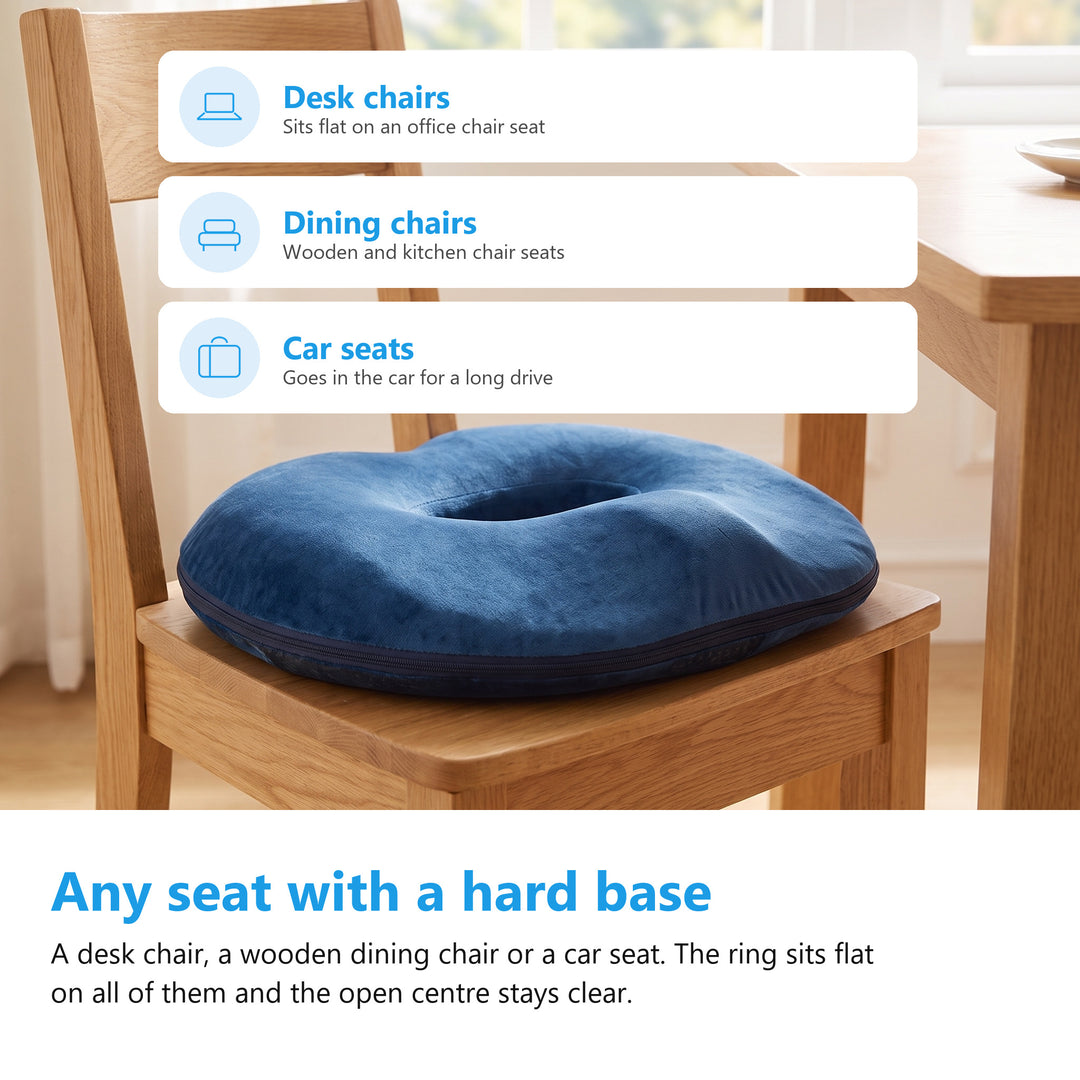 Navy donut cushion on the seat of an oak dining chair in a bright kitchen