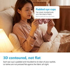 Padded 3D contoured eye cups of a silk eye mask, held up before putting it on