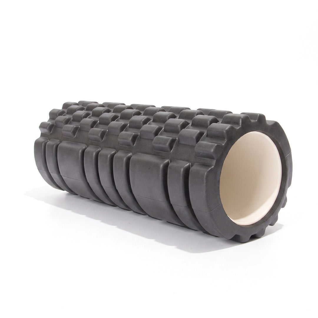 Black textured foam roller with a raised grid surface and hollow core on a white background