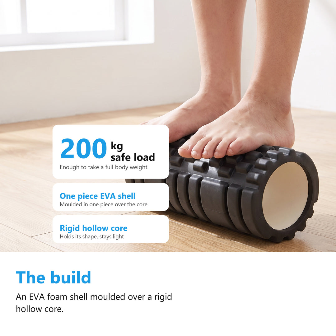 A person standing on the black textured foam roller on a wooden floor, showing the 200kg safe load