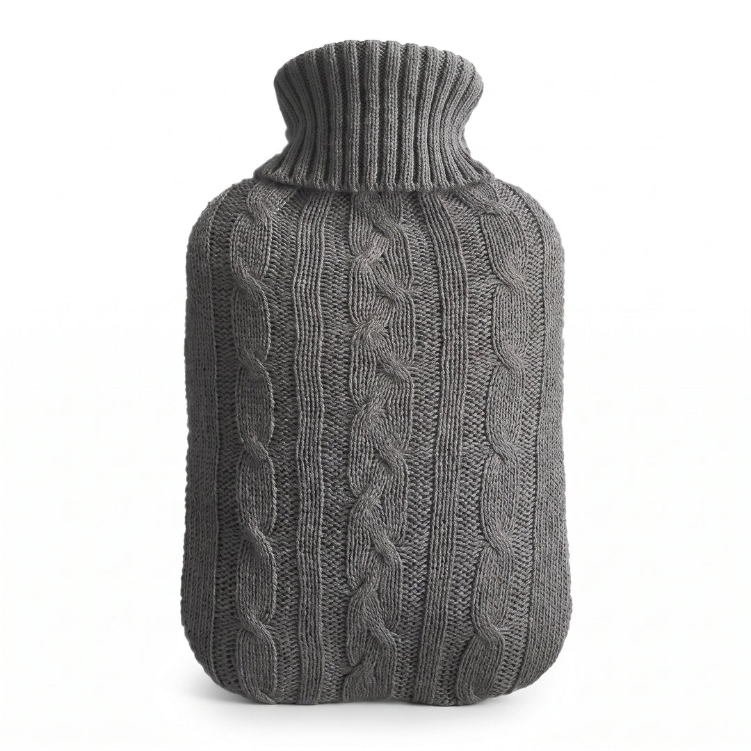 Hot water bottle with a grey knitted cable cover on a white background