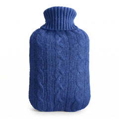 Hot water bottle with a blue knitted cable cover on a white background