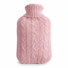 Hot water bottle with a pink knitted cable cover on a white background
