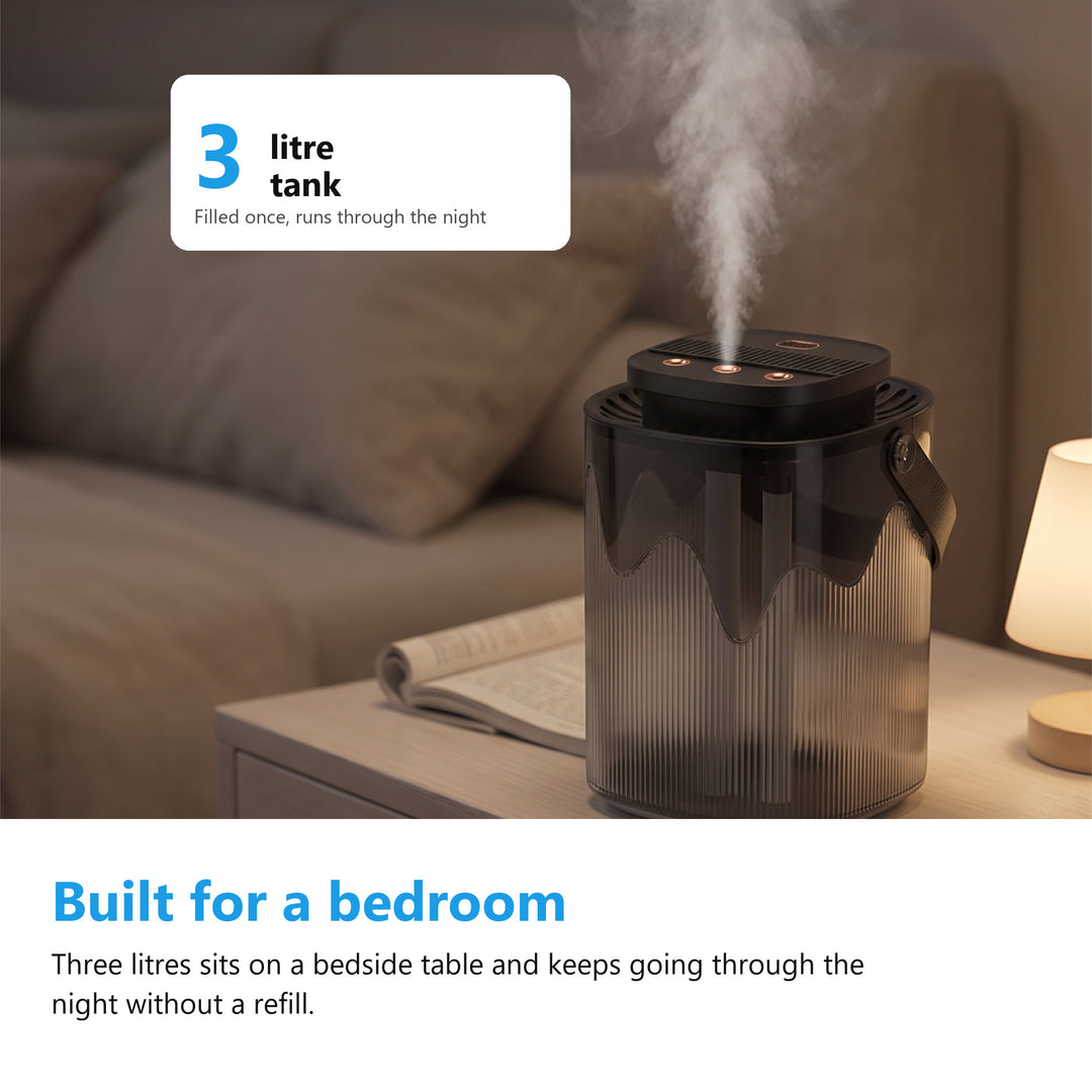 Cool mist humidifier running on a bedside table in a bedroom