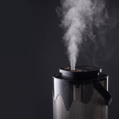 Cool mist rising from the three nozzles of the humidifier