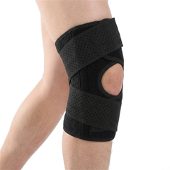 Cycling sports knee pad in black on the left knee, open patella wrap