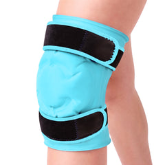 Light blue knee ice pack gel sleeve worn on a knee against a white background, the same view, the padded front panel and both black straps in view