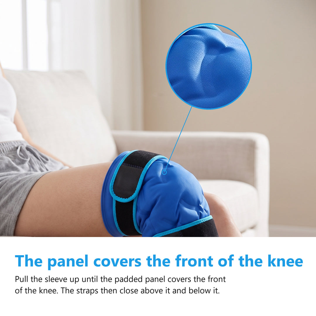 Woman seated on a pale sofa wearing the blue knee ice pack gel sleeve, with the padded panel covering the front of her knee