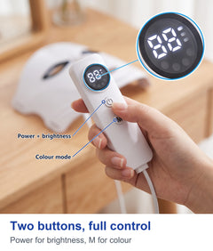 Hand holding the white LED face mask controller with display
