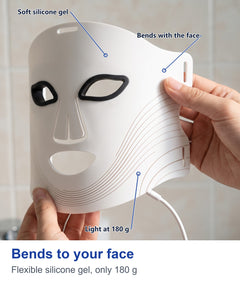 Hands bending the white flexible silicone LED face mask