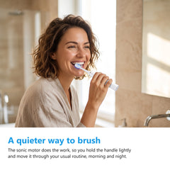 Woman brushing her teeth with the electric toothbrush