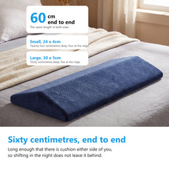 Navy velvet wedge cushion lying on a bed, labelled 60cm end to end with the small and large sizes beside it