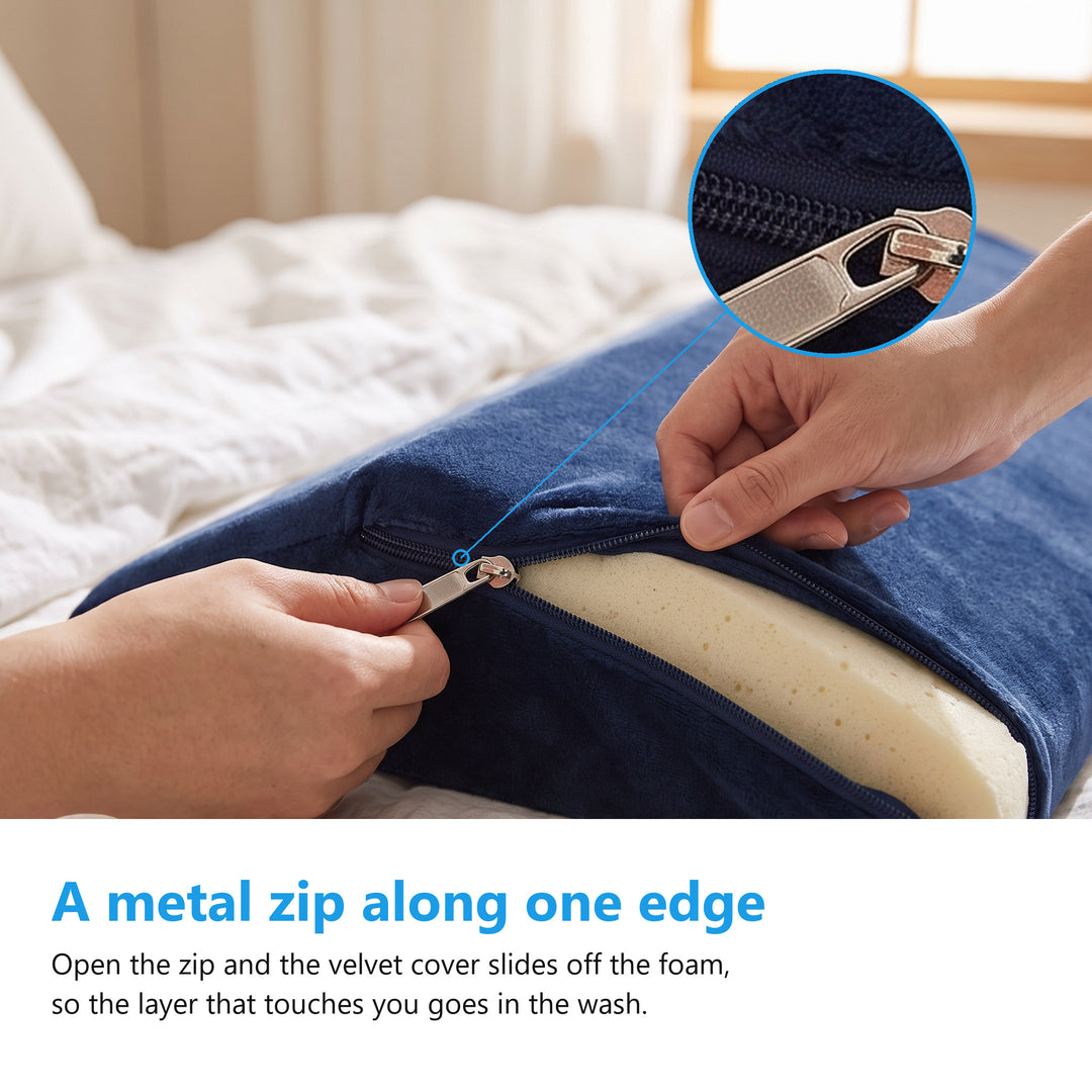 Two hands opening the metal zip on the navy velvet cover of the wedge cushion with the cream memory foam visible inside
